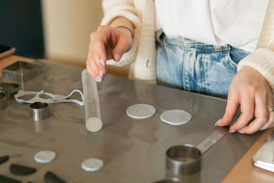 Midsection of woman holding food on table