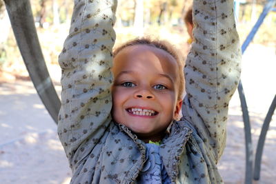 Portrait of cute girl smiling while playing at playground