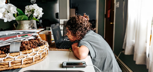 Midsection of woman having food on table