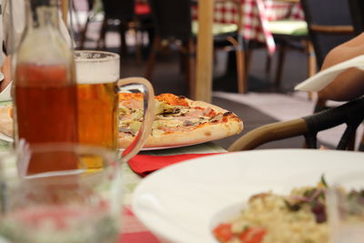 Close-up of pizza served on table in restaurant