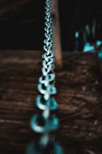 Close-up of chain hanging on table