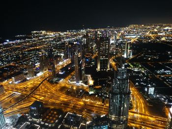 High angle view of city lit up at night