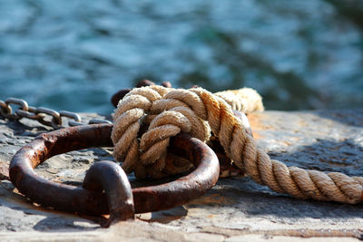 Close-up of rope tied on metal ring 