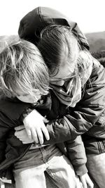 Rear view of mother and daughter outdoors