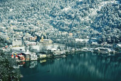 High angle view of townscape by river in city