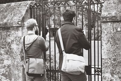 Rear view of woman standing against white wall