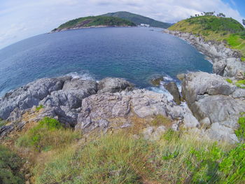 Scenic view of sea and mountains against sky