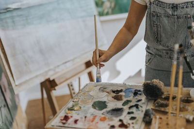 Artist painting in studio