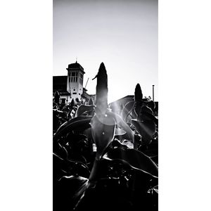 Digital composite image of hand against built structure