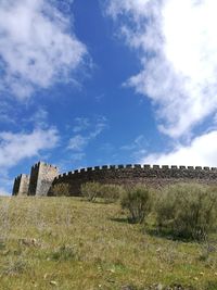 Hay bales on field against sky