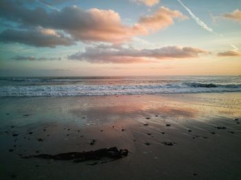 Scenic view of beach against sky during sunset