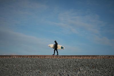 Full length of woman standing against sky
