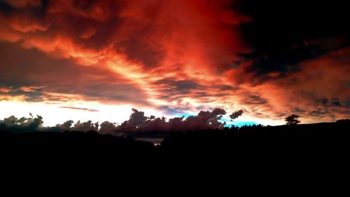 Silhouette landscape against dramatic sky