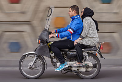 Side view of woman riding bicycle