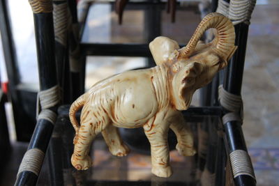 Close-up of elephant figurine on glass table