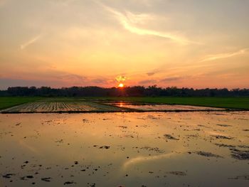 Scenic view of land against sky during sunset