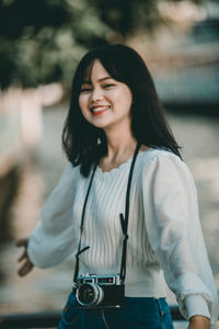 Portrait of a smiling young woman standing outdoors