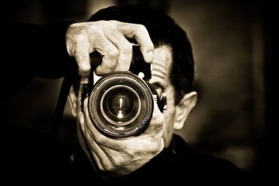 Close-up of man holding camera