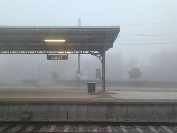 Railroad tracks against sky during foggy weather