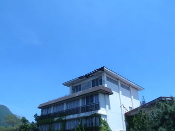 Low angle view of building against blue sky