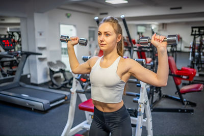 Young woman exercising in gym