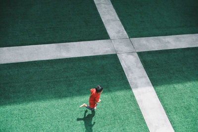 High angle view of boy running on stadium