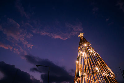Low angle view of buildings against sky at night