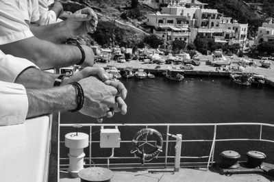 Man holding ice cream by boat