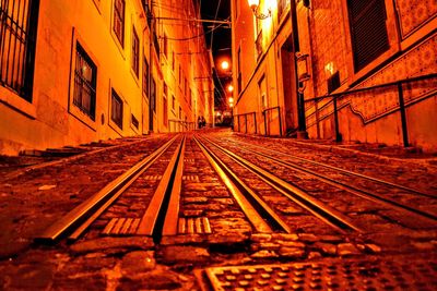 Railroad tracks against sky at night