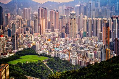 High angle view of buildings in city against sky, kowloon side, hong kong. 