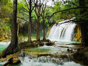 Scenic view of river flowing through rocks