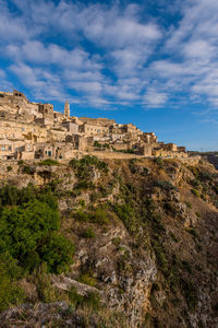 Buildings at sassi di matera against cloudy sky