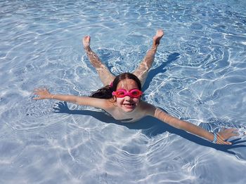 High angle portrait of girl swimming in pool