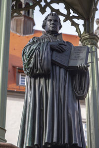 Low angle view of statue against building