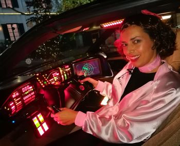 Portrait of smiling woman sitting in car
