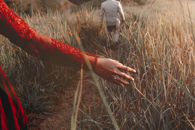 Midsection of woman on field