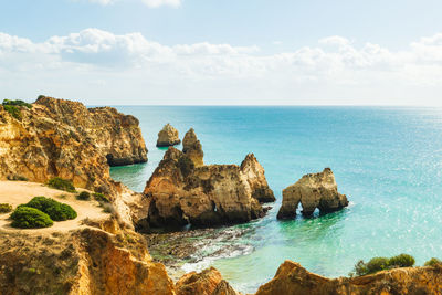 High level view of sea stacks and natural arches, alvor, algarve, portugal, europe