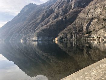 Scenic view of lake by mountains against sky