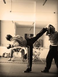 Full length of woman standing by railing