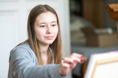 Portrait of smiling young woman using mobile phone