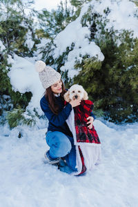 Woman with dog in snow