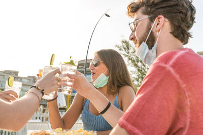 Portrait of a smiling young man drinking glass