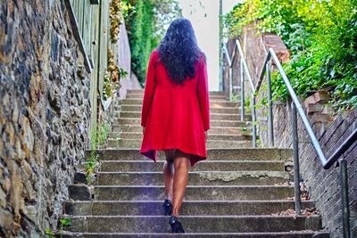 Rear view of woman walking on steps