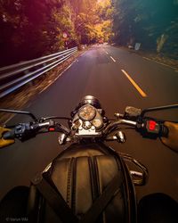 Cropped hand of man riding motorcycle