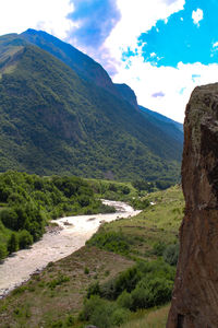 Scenic view of landscape and mountains against sky