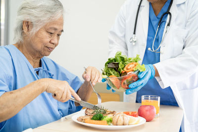 Asian senior woman patient eating breakfast and vegetable healthy food  