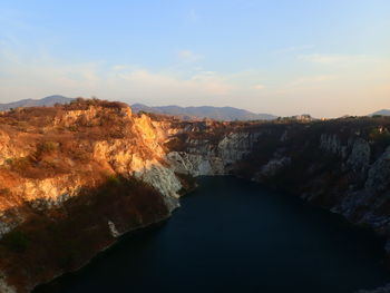 High angle view of river amidst mountains against sky