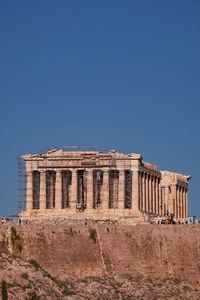 Low angle view of historical building against clear blue sky