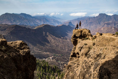 Scenic view of rocks and mountains against sky