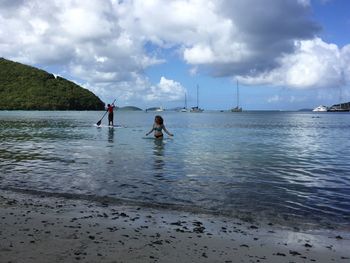 Men on beach against sky